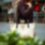 Elegant tote bag with integrated coffee cup holder showcased in an urban setting