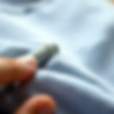 Effective Lint Removal from Fabric Close-up view of lint being removed from a fabric, highlighting the effectiveness of a manual lint remover.