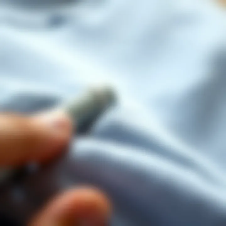 Effective Lint Removal from Fabric Close-up view of lint being removed from a fabric, highlighting the effectiveness of a manual lint remover.