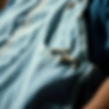 Close-up view of fabric texture and detailing on distressed overalls