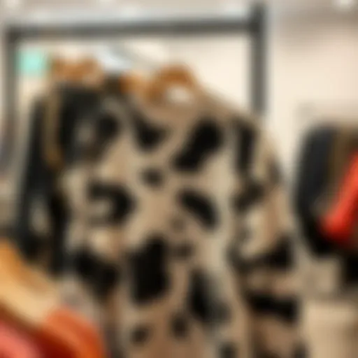 A stylish cow print fleece pullover displayed on a hanger