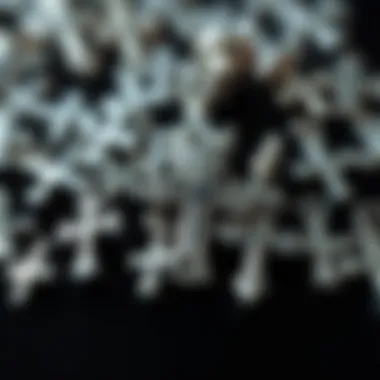 A close-up of various silver cross nail charms highlighting their unique styles.